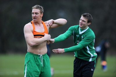 04.02.10 - Wales Rugby Training -  Dan Biggar helps Andy Powell with his vest during training. 