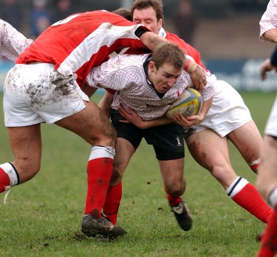 030104 - Aberavon v Llanelli Aberavon's Darren Ryan is held by Llanelli's defence  