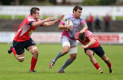 081016 - Aberavon v Llanelli - Principality Premiership - Chris Davies of Aberavon is tackled by Simon Gardiner and Ioan Hughes of Llanelli