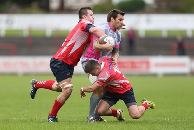 081016 - Aberavon v Llanelli - Principality Premiership - Chris Davies of Aberavon is tackled by Simon Gardiner and Ioan Hughes of Llanelli