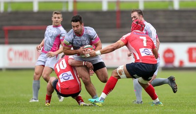 081016 - Aberavon v Llanelli - Principality Premiership - Rheon James of Aberavon is tackled by Ioan Hughes and Josh Macleod of Llanelli