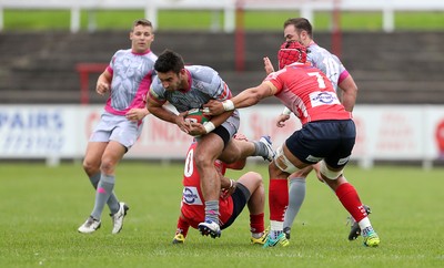 081016 - Aberavon v Llanelli - Principality Premiership - Rheon James of Aberavon is tackled by Ioan Hughes and Josh Macleod of Llanelli