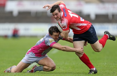 081016 - Aberavon v Llanelli - Principality Premiership - Ryan Conbeer of Llanelli is tackled by Richard Carter of Aberavon