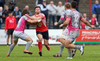 081016 - Aberavon v Llanelli - Principality Premiership - Dion Jones of Llanelli is tackled by Joe Tomalin-Reeves of Aberavon