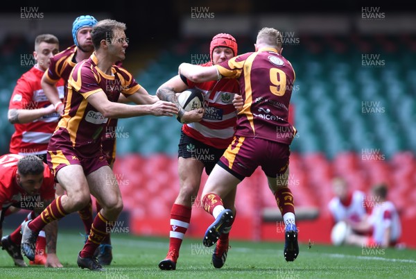 280419 - Abergavenny v Oakdale - WRU National Bowl Final - Connor Jenkins of Oakdale is tackled by Rhob Connick of Abergavenny