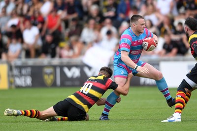110525 - Aberteifi RFC v Newport Saracens - Mens Division 3 Cup Final - Stef Morgan of Newport Saracens is challenged by Jac Davies of Aberteifi