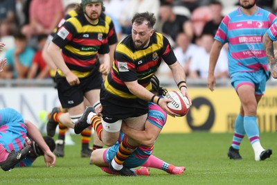 110525 - Aberteifi RFC v Newport Saracens - Mens Division 3 Cup Final - Shaun Leonard of Aberteifi is challenged by Dex Lewis of Newport Saracens