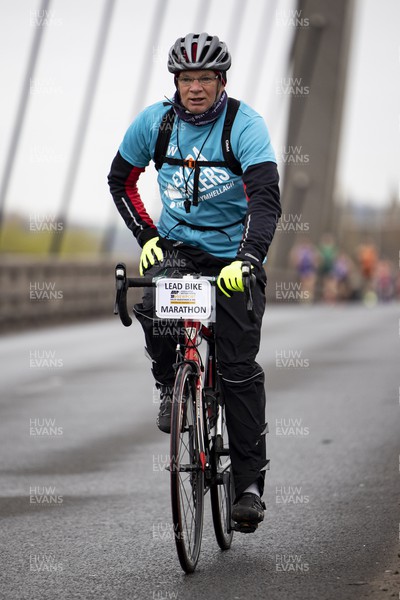 160423 - ABP Newport Wales Marathon and 10K - Run 4 Wales extra miler volunteer crosses the Newport Southern Distributor Bridge on a bike
