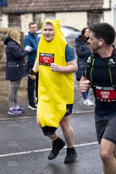 160423 - ABP Newport Wales Marathon and 10K - Runner in a banana costume passes through Magor 