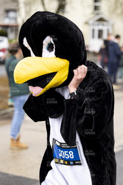 160423 - ABP Newport Wales Marathon and 10K - Runner in a penguin costume passes through Magor 