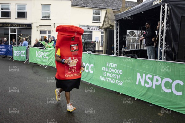 160423 - ABP Newport Wales Marathon and 10K - Runner in post box costume passes through Magor 