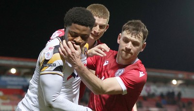 110325 - Accrington Stanley v Newport County - Sky Bet League 2 - Bobby Kamwa of Newport is held off the ball by Donald Love of Accrington