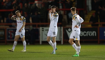 110325 - Accrington Stanley v Newport County - Sky Bet League 2 - James Clarke of Newport and Joe Thomas of Newport and Kai Whitmore of Newport dejected after 5th goal for Accrington