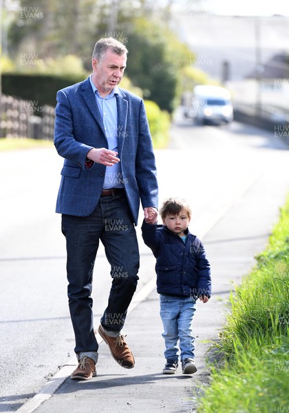 060521 -  Plaid Cymru leader Adam Price on his way to vote in the Senedd election with his son at his local polling station Pontargothi Memorial Hall, Pontargothi, Carmarthen