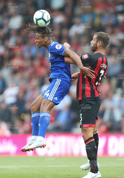 110818 - AFC Bournemouth v Cardiff City, Premier League - Bobby Reid of Cardiff City beats Steve Cook of Bournemouth as he heads the ball