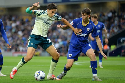 190825 - AFC Wimbledon v Cardiff City - Sky Bet League 1 - Joel Colwill of Cardiff City is challenged by Steve Seddon of Wimbledon
