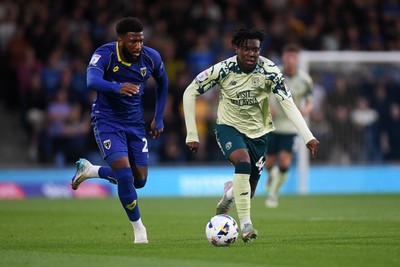 190825 - AFC Wimbledon v Cardiff City - Sky Bet League 1 - Ronan Kpakio of Cardiff City is challenged by Myles Hippolyte of Wimbledon