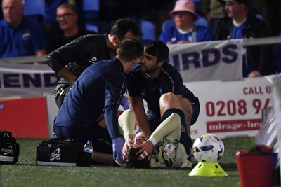 190825 - AFC Wimbledon v Cardiff City - Sky Bet League 1 - Ollie Tanner of Cardiff City is stretched off after picking up an injury