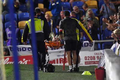 190825 - AFC Wimbledon v Cardiff City - Sky Bet League 1 - Ollie Tanner of Cardiff City is stretched off after picking up an injury