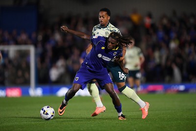 190825 - AFC Wimbledon v Cardiff City - Sky Bet League 1 - Chris Willock of Cardiff City is challenged by Nathan Asiimwe of Wimbledon