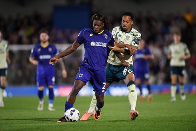 190825 - AFC Wimbledon v Cardiff City - Sky Bet League 1 - Chris Willock of Cardiff City is challenged by Nathan Asiimwe of Wimbledon