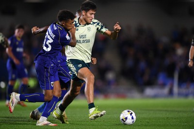 190825 - AFC Wimbledon v Cardiff City - Sky Bet League 1 - Rubin Colwill of Cardiff City is challenged by Leo Young of Wimbledon