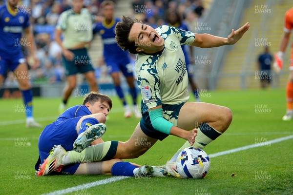 190825 - AFC Wimbledon v Cardiff City - Sky Bet League 1 - Joel Colwill of Cardiff City is challenged by Steve Seddon of Wimbledon