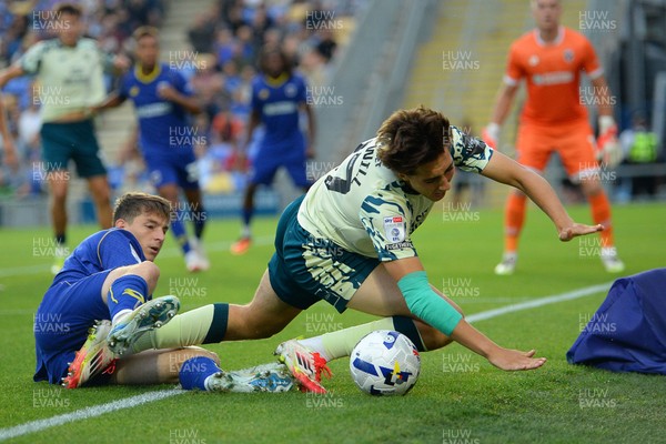 190825 - AFC Wimbledon v Cardiff City - Sky Bet League 1 - Joel Colwill of Cardiff City is challenged by Steve Seddon of Wimbledon