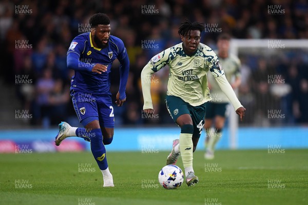 190825 - AFC Wimbledon v Cardiff City - Sky Bet League 1 - Ronan Kpakio of Cardiff City is challenged by Myles Hippolyte of Wimbledon