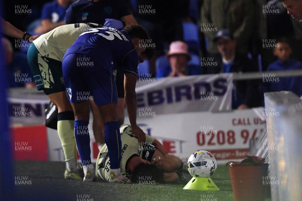 190825 - AFC Wimbledon v Cardiff City - Sky Bet League 1 - Ollie Tanner of Cardiff City is stretched off after picking up an injury
