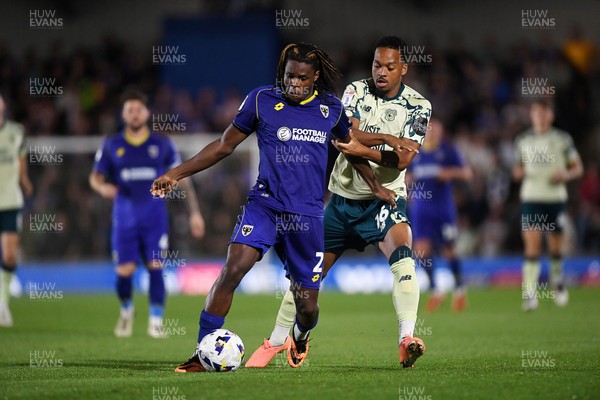 190825 - AFC Wimbledon v Cardiff City - Sky Bet League 1 - Chris Willock of Cardiff City is challenged by Nathan Asiimwe of Wimbledon