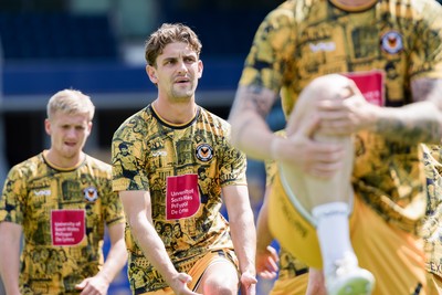 080826 - AFC Wimbledon v Newport County - Carabao Cup First Round - Harrison Biggins of Newport County warming up
