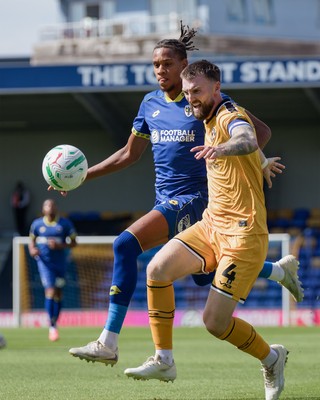 080826 - AFC Wimbledon v Newport County - Carabao Cup First Round - Alistair Smith of AFC Wimbledon and Kyle Cameron of Newport County in action