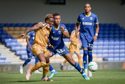 080826 - AFC Wimbledon v Newport County - Carabao Cup First Round - Shaquille Gwengwe of Newport County and Isaac Ogundere of AFC Wimbledon in action