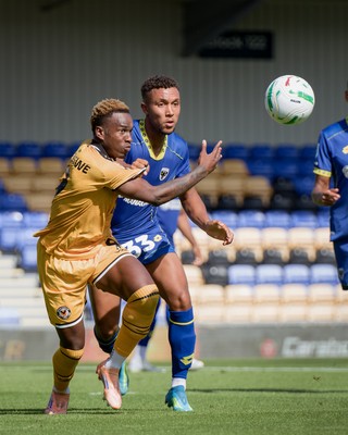 080826 - AFC Wimbledon v Newport County - Carabao Cup First Round - Shaquille Gwengwe of Newport County and Isaac Ogundere of AFC Wimbledon in action