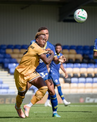 080826 - AFC Wimbledon v Newport County - Carabao Cup First Round - Shaquille Gwengwe of Newport County and Isaac Ogundere of AFC Wimbledon in action