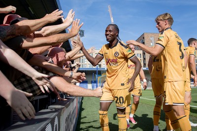 080826 - AFC Wimbledon v Newport County - Carabao Cup First Round - Yahya Bamba of Newport County celebrates his goal with fans