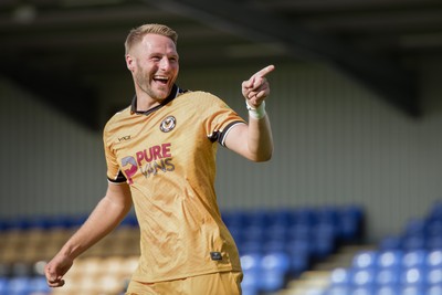 080826 - AFC Wimbledon v Newport County - Carabao Cup First Round - Cameron Norman of Newport County celebrates after scoring a penalty during the penalty shootout