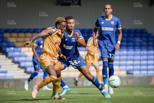 080826 - AFC Wimbledon v Newport County - Carabao Cup First Round - Shaquille Gwengwe of Newport County and Isaac Ogundere of AFC Wimbledon in action