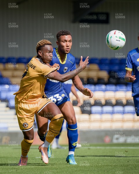 080826 - AFC Wimbledon v Newport County - Carabao Cup First Round - Shaquille Gwengwe of Newport County and Isaac Ogundere of AFC Wimbledon in action
