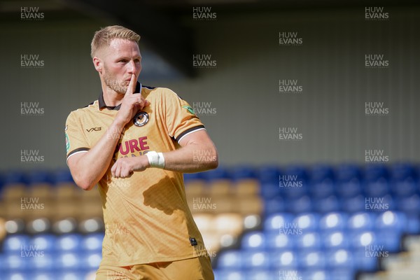 080826 - AFC Wimbledon v Newport County - Carabao Cup First Round - Cameron Norman of Newport County celebrates after scoring a penalty during the penalty shootout