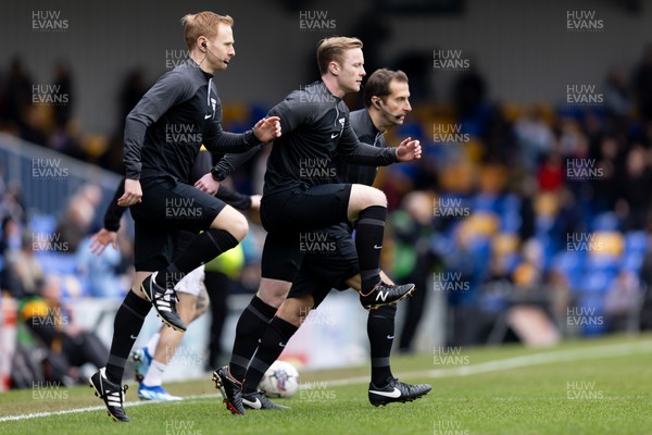 160324 - AFC Wimbledon v Newport County - Sky Bet League 2 - Thomas Parsons match referee and his assistants James Vallance and Steven Scott warming up prior to the kick off