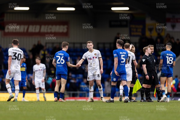 160324 - AFC Wimbledon v Newport County - Sky Bet League 2 - Bryn Morris of Newport County AFC and Jack Currie of AFC Wimbledon greet each other after the final whistle