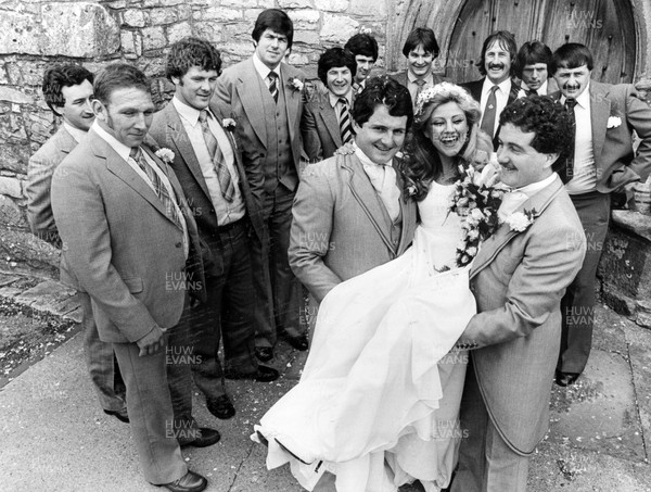 040880 - Picture shows Wales and Lions player Alan Phillips and best man Keith Williams lift Alan's new wife Cerry Shirley of Hazelwood Road, Porthcawl after their wedding at St Johns Church, Newton, Porthcawl