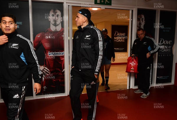 211114 - New Zealand All Blacks Rugby Training -Sonny Bill Williams walks past a poster of Sam Warburton