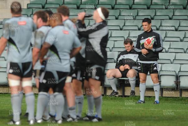 04.11.09 - New Zealand Rugby Training - Dan Carter looks on as he sits out of training with suspended Tony Woodcock(L). 