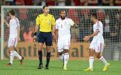 090914 - Andorra v Wales - 2016 Euro Qualifier -Ashley Williams and Neil Taylor of Wales talks to Referee Slavko Vincic following Ildefons Lima goal