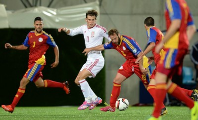 090914 - Andorra v Wales - 2016 Euro Qualifier -Gareth Bale of Wales is tackled by Josep Ayala of Andorra