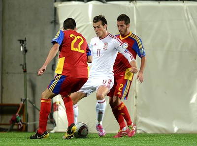 090914 - Andorra v Wales - 2016 Euro Qualifier -Gareth Bale of Wales is challenged by David Maneiro and Christian Martinez of Andorra