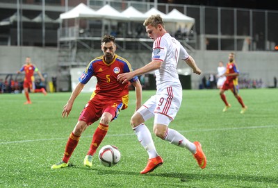 090914 - Andorra v Wales - 2016 Euro Qualifier -Simon Church of Wales is challenged by Emili Garcia of Andorra